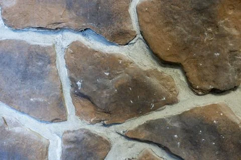 Close-Up of Brown Fieldstone Wall Texture with Irregular Natural Stone Patter Stock Photos