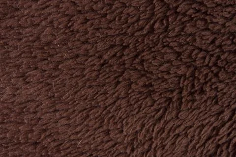 Close-Up Brown Fleece Texture Background Cozy Fabric Fur Shearling Material.. Foto stock