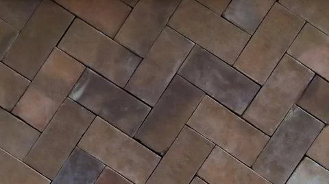 Close-up of Brown Interlocking Brick Floor Pattern with a Rustic Herringbon.. Stock Photos