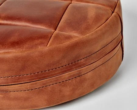 Close-up brown leather patchwork floor cushion with hidden side zipper Fotos de archivo