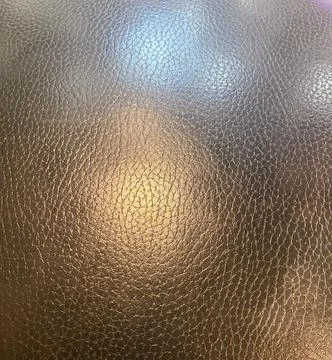Close-up of brown leather textured surface with light reflections Stock Photos