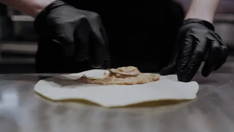 Close-Up of Brown Sauce Being Smeared on Lavash by Chef in Gloves 스톡 동영상 307058272