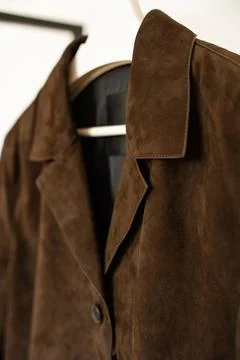 Close-up of brown suede jacket collar and lapel with soft texture and visible Stock Photos