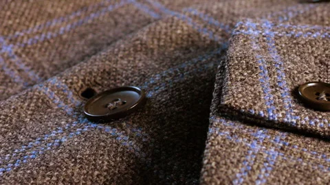 Close-up of a brown tweed woolen jacket lapel showing its elegant finish. 動画素材 346185911