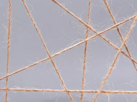 Close-up of brown twine strings on gray background Photos