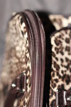 Close Up Brown Zipper Edge on Leopard Print Travel Bag Stock Photos