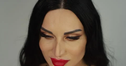Close up of of a brunette with red lips in a studio with a white bac Stock Footage 167990174