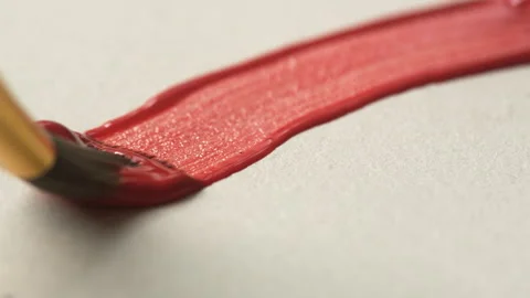 Close-up of brush bristles on paper drawing a red line with paint, oil or g.. Stock Footage 336974457