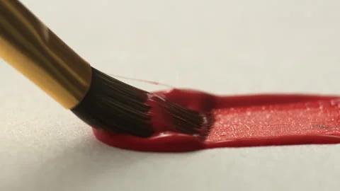 Close-up of brush bristles on paper drawing a red line with paint, oil or g.. Stock Footage 337179081