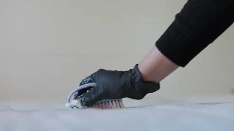 Close up brush cleans a mattress surface, ensuring meticulous cleaning and Stock Footage 309104329