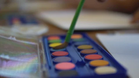 Close up on brush dissolving blue water color paint Vidéo 109428484