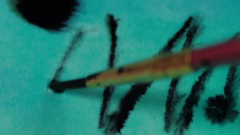Close up of brush drawing by black ink on wet paper. 4K resolution Stock Footage 133589016