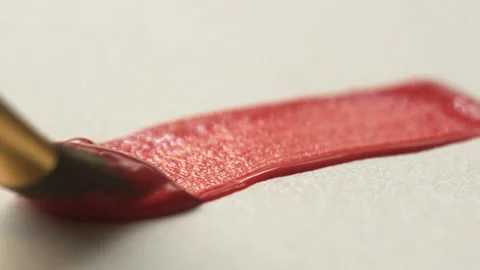 A close-up of a brush leaving a red line on white paper. The process of bru.. Stock Footage 337305611