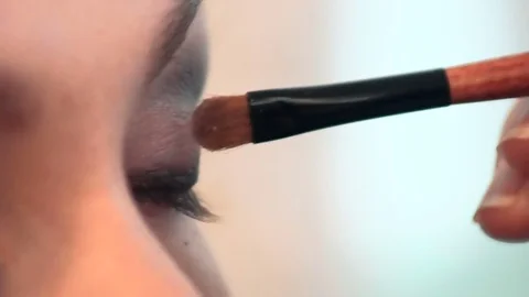 Close-up of a brush with make-up. a painted eyelid on the female face Stock Footage 82498590
