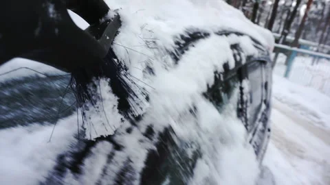 Close-up of a brush sweeping snow from the car. Stock Footage 194800530