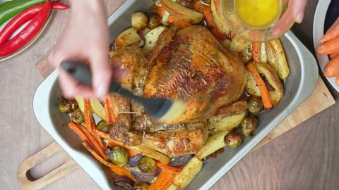 Close-up of brushing and marinating with sauce a whole chicken after grilling. Stock Footage 145117093