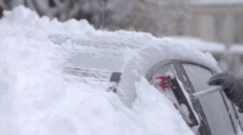 Close-Up Of Brushing The Snow Off The Snow Covered Car Stock Footage 45392470