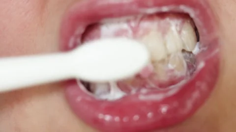 Close-up of brushing teeth with foam and toothbrush, oral hygiene routine Stock Footage 340261317