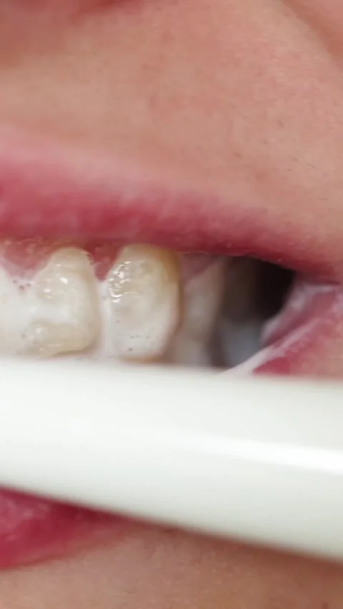 Close-up of brushing teeth with foam and toothbrush for oral hygiene Stock-Footage 343838156