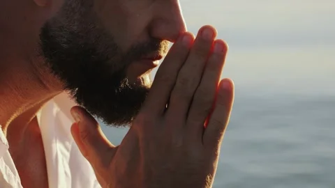 Close-up of a brutal bearded mans face on the ocean shore. Stock Footage 315721730