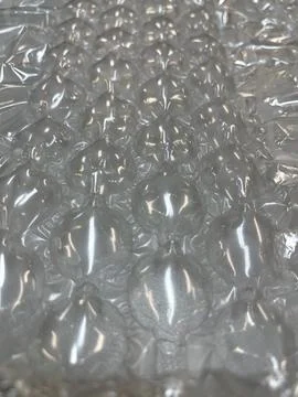 Close-up of bubble wrap texture with air-filled pockets. Transparent plastic Stock Photos