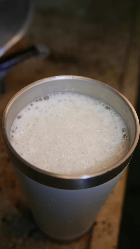 Close-up of bubbles bursting in beer foam. A beer on the table. A beer tumbler Stock Footage 331112067