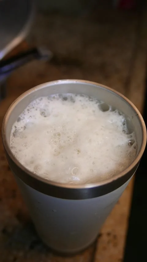 Close-up of bubbles bursting in beer foam. Beer on the table. A beer tumbler Stock Footage 332819889