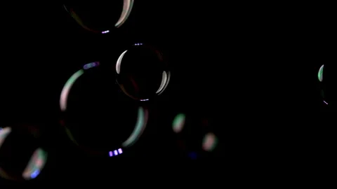 Close up of Bubbles Floating up Against a Black Background Stock Footage 270399216