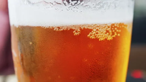 Close up of bubbles forming into foam in a beer glass Stock Footage 311537942