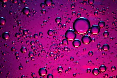 Close-up of bubbles in pink liquid. Stock Photos