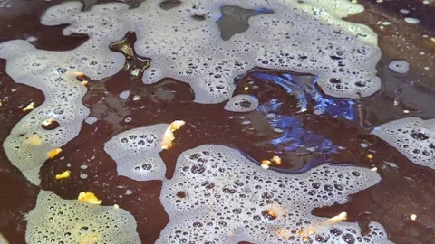 Close-up of bubbling dark brine solution for tofu marinating in food factory. Video stock 330595618