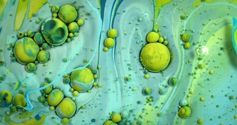 Close-up of bubbling green liquid with golden orbs rising. Abstract flowing moti 動画素材 340450307