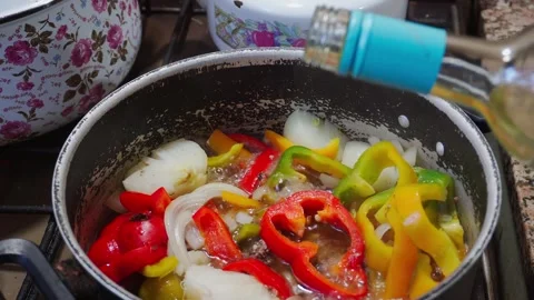 Close-up of a bubbling pot of meat and vegetables with white wine being add.. Stock Footage 286763023