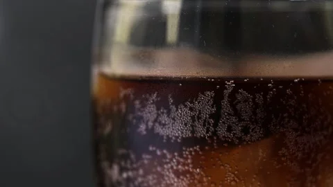 Close-Up of Bubbly Beverage with Ice Cubes on Dark Backgroun Stock Footage 314833287