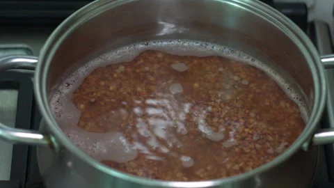 Close-up of Buckwheat Boiling in a Pot on a Stove for Healthy Cooking Stock-Footage 339630728