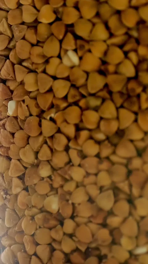 Close-up, buckwheat into plastic packaging, box, rotates on black background. Stock-Footage 321236044
