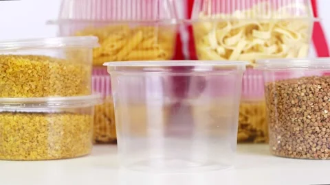 Close-up, buckwheat is poured into plastic packaging. background from the same 스톡 동영상 131015717