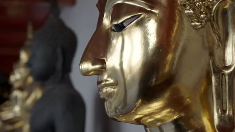 Close up of a buddhist gold statue in a temple in Bangkok Stock Footage 75535513
