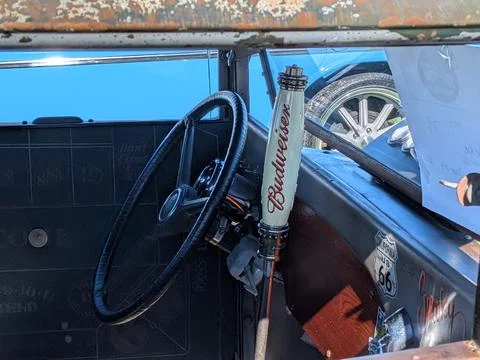 Close-up of a Budweiser-branded stick shift inside a classic custom car Фото