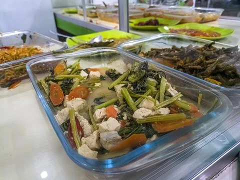 A close up of a buffet display featuring various dishes, including a vegeta.. Stock Photos