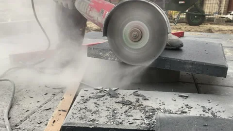 Close up of builder cuts paving slabs using angle grinder Video stock 224713665