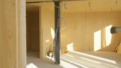 CLOSE UP: Builder leaves the construction site with toolbox and ladder in hand. Stock Footage 124930585