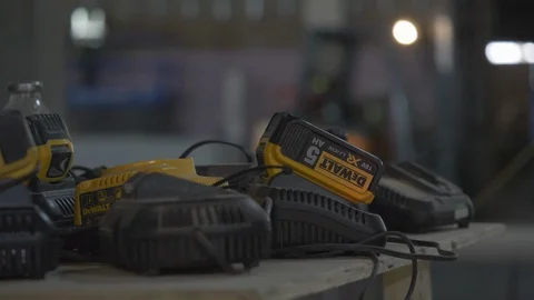 Close Up Of Builders Batteries Charging With Builder In Background Video stock 92700148