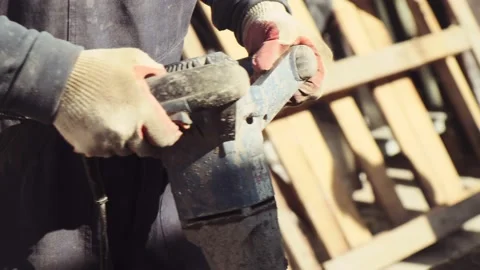 Close-up of a builder's hands holding an electric construction mixer. Capital re Stock Footage 201186430