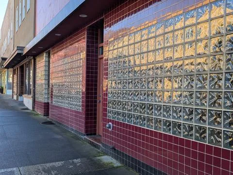 Close-up of building facade featuring square tiles and glass block architecture 库存照片