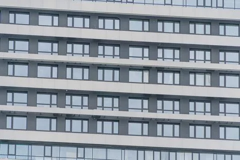 Close-up of a building facade with multi-windowed design, windows varying in  스톡 사진