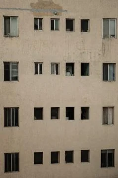 Close up to a building, pattern of windows of a gray building Stock Photos