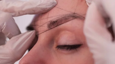 Close-up of building a universal, classic sketch of symmetrical eyebrows, before Video stock 106891355