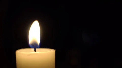 Close-up of bulging candle burns, the wind blows and candle goes out in dark. Stock Footage 121957244