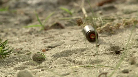 Close up of bullets falling to the ground Stock Footage 43768070